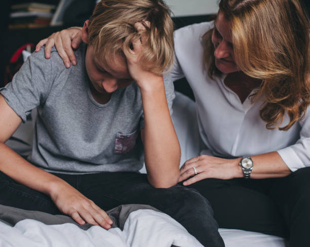 Mother consoling her upset son