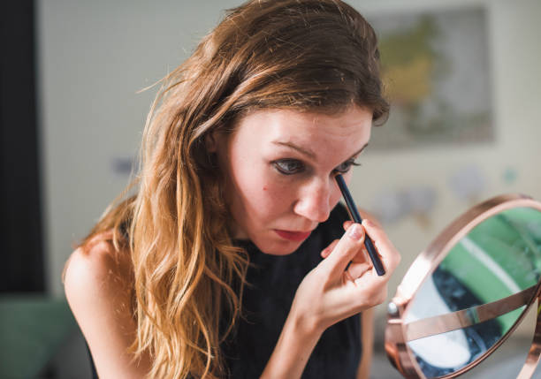 istock Girl applying makeup on her face 2157899545