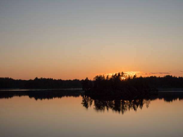 istock island on a forest lake at sunset 2157900786