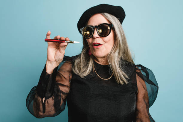 istock Senior woman smoking electronic cigarette 2157901732