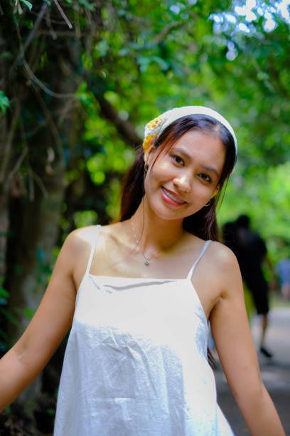 istock A young Asian woman admires a tree. 2157904871