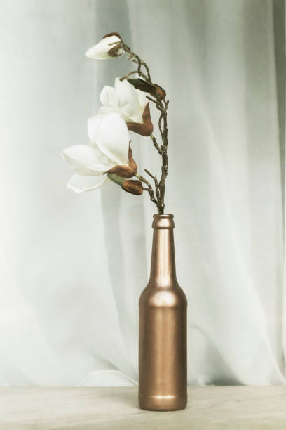 istock White magnolia in a copper glass bottle 2157905001