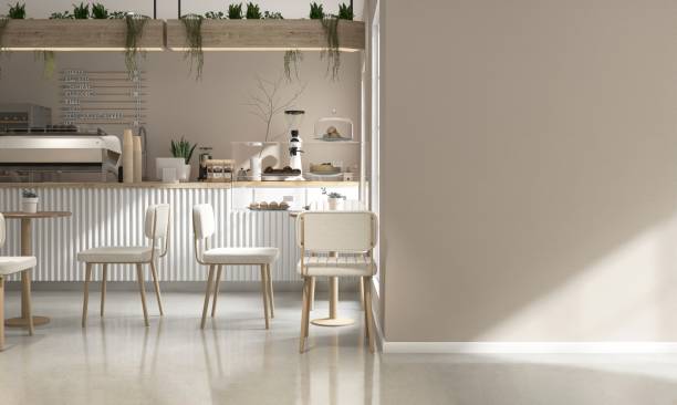 istock Blank beige wall of modern cafe, bakery with counter, professional espresso machine, cake display, tables, chairs, sunlight from window 2157905120