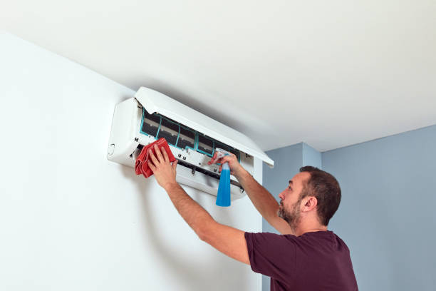 istock Man cleaning and maintaining air condition unit. 2157906596