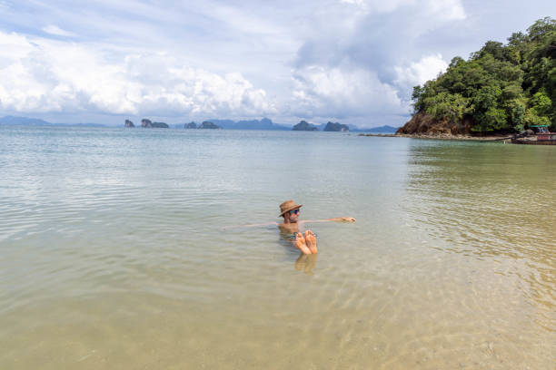 istock Man Floating with Arms Outstretched in Shallow Sea 2157906654