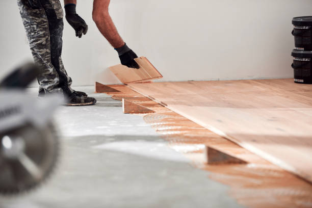 istock Professional handyman installing laminate flooring in a new apartment. 2157906807