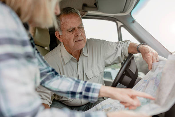 istock Senior couple searching for direction on a map 2157909186