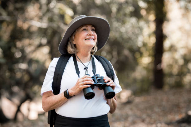 istock Active old woman using binoculars to see the beauty of nature 2157909228