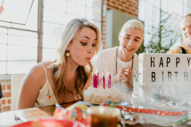 istock Blowing out the candles on a birthday cake 2157909734