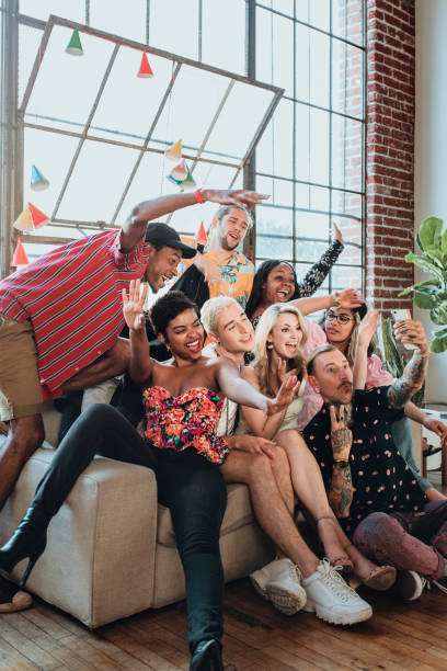 istock Diverse group of friends taking a selfie at a party 2157909882