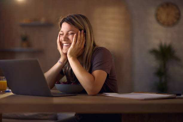 istock Happy woman enjoying while using laptop at home. 2157909925