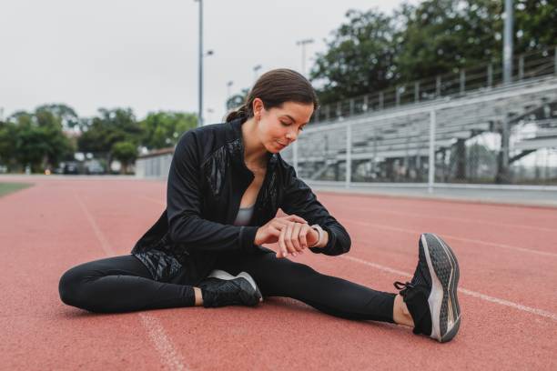 istock Woman warming up by stretching on a running track 2157911982