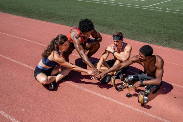 Team of diverse athletes stacking hand before the race