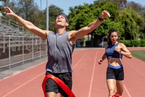 istock Man runner winnning with arms open, athletic race competition 2157912121
