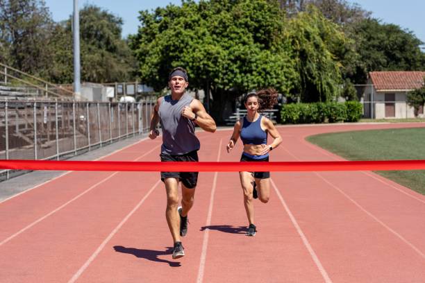 istock Man and woman runners competing, athletic race competition 2157912126