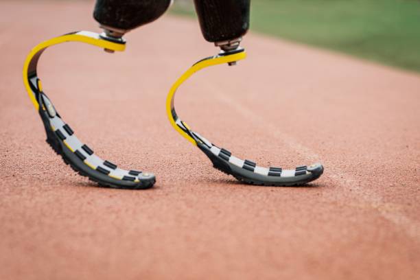 istock Athlete with prosthetic legs on a running track 2157912138