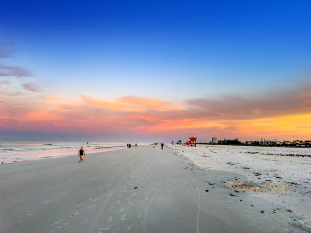 istock People enjoy tropical sandy beach during sunrise 2157912145