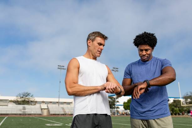 istock Athlete and coach discussing fitness tracker and performance 2157912181