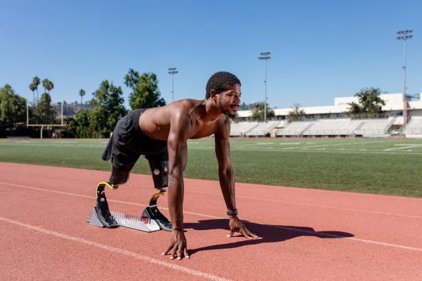 istock Paralympic sprinter with prosthetic blades started racing from a starting block 2157912301