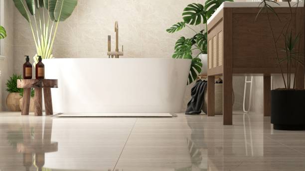 istock White freestanding bathtub in sunlight from window on beige marble tile wall bathroom with tropical trees 2157913283