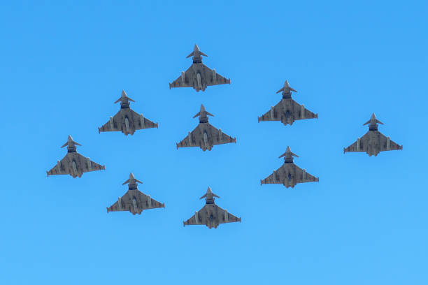 Many Eurofighter Typhoon fighter jets flying in formation against a bright blue sky. Spanish Air Force stock photo