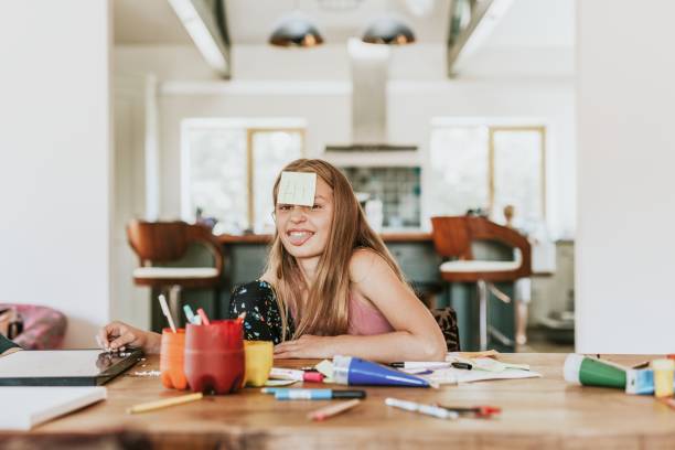 istock Sticky note on young girl forehead, homeschooling in the new normal 2157914627