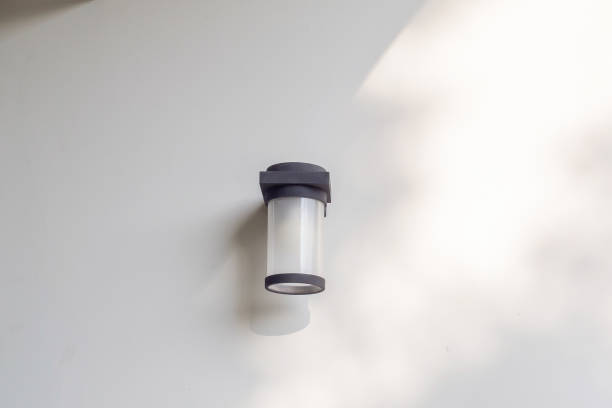 istock Outdoor cylinder lamp with tree leaves shadow on concrete wall 2157915196