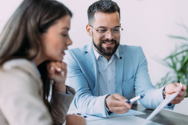 colleagues discussing project at workplace. - financieel adviseur stockfoto's en -beelden