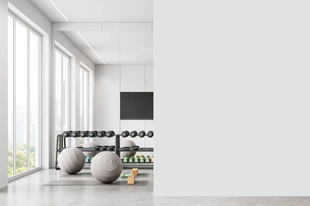 istock Home gym interior with dumbbell rack and mat, tv and window. Mockup wall 2157915577