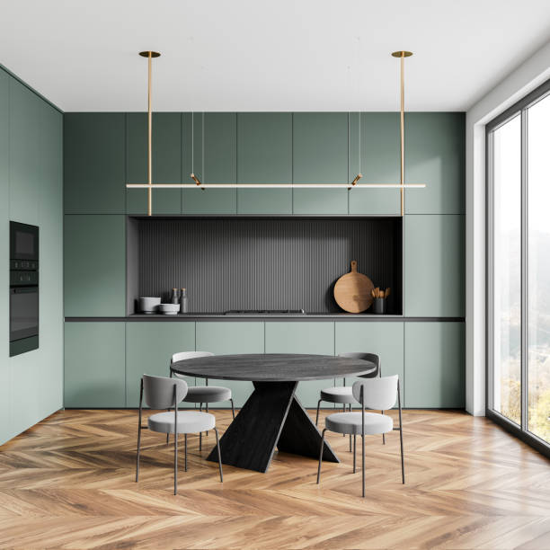 istock Green home kitchen interior with dining table and cooking cabinet, window 2157915729
