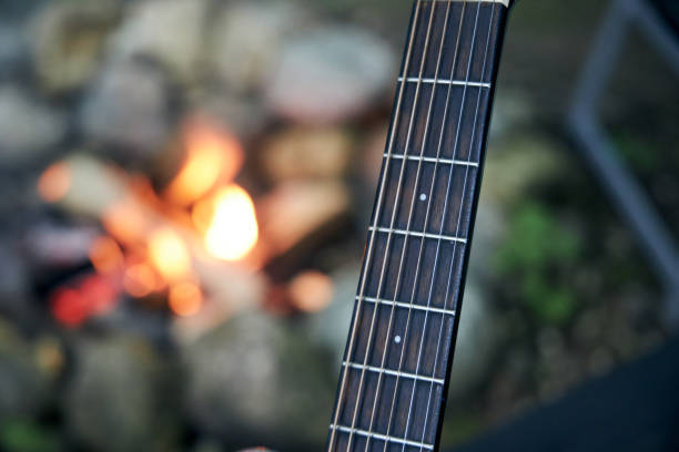 istock guitar fingerboard in the background of a campfire 2157915742