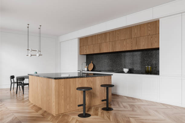 istock Modern kitchen interior with wooden features, a central island, and pendant lighting on a clean, bright background. 3D Rendering 2157916026