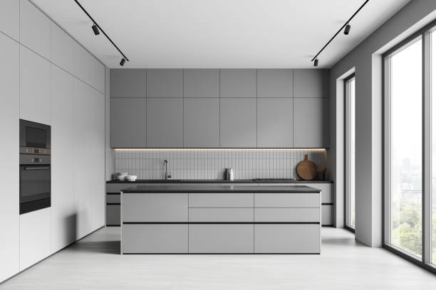 istock Grey home kitchen interior with cooking cabinet and bar island, panoramic window 2157916343