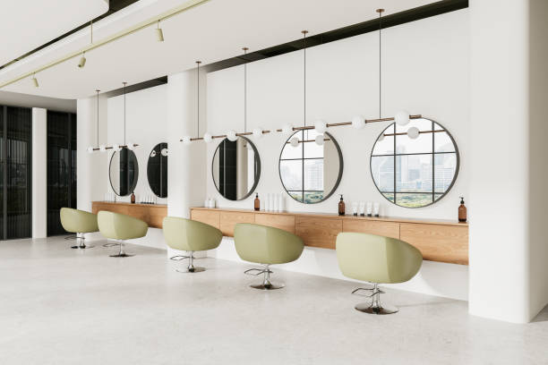 istock Elegant beauty salon interior with armchairs and round mirrors, panoramic window 2157916439