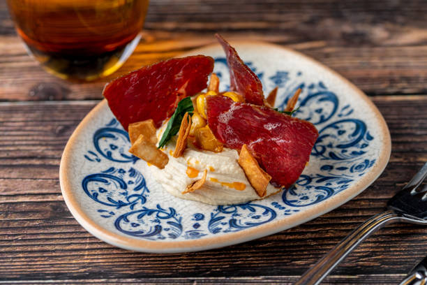 istock Hummus with pastrami, traditional Turkish dish, on wooden table 2157917154