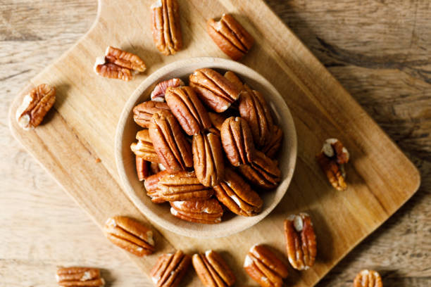 istock Pecan nuts in a wooden bowl 2157917203