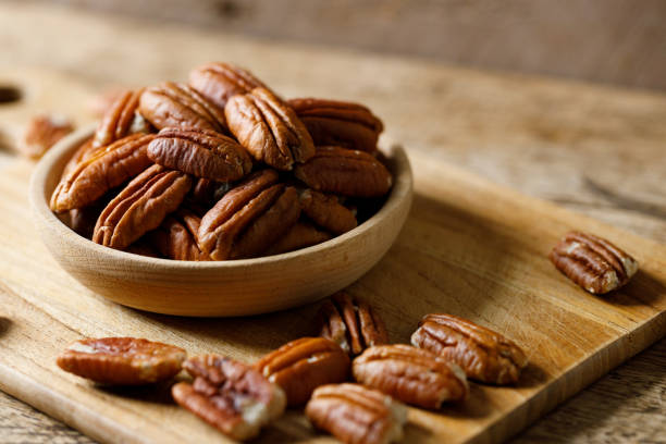 Single half of pecan , isolated on white background.