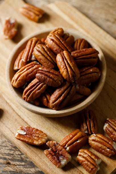 istock Pecan nuts in a wooden bowl 2157917214