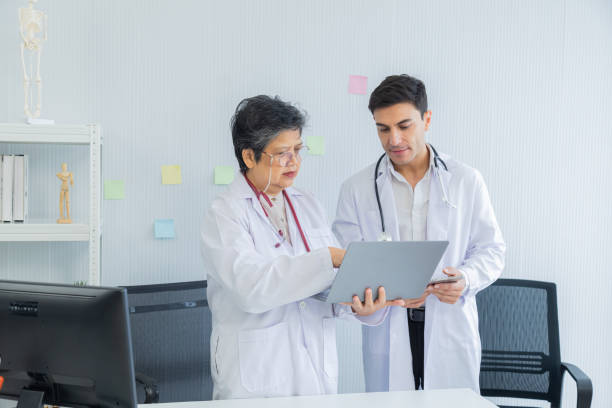 istock Two collaboration doctors team from professional hospital discussing patient information on laptop and tablet. medical office specialist private conference setting in pediatric care with data analysis 2157918705
