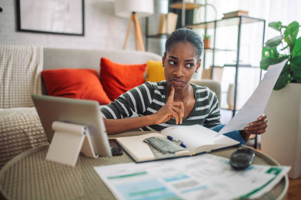 istock Confused black woman paying the bills 2157919990
