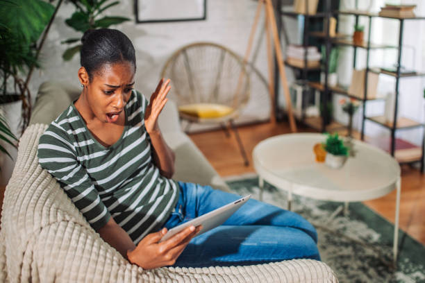 istock Young black woman using a digital tablet and looking sad and shocked 2157920079
