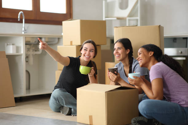 istock Three happy roommates planning decoration moving house 2157920706