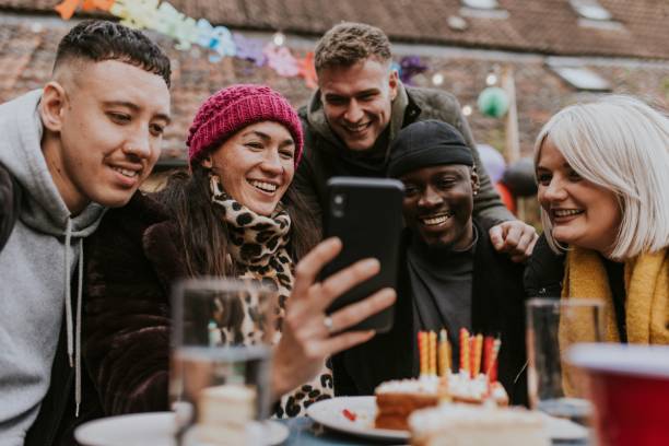 istock Man lexamining a friend group selfie 2157922192