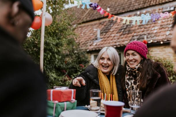 istock Happy friends at a birthday dinner table 2157922246