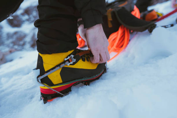 istock Man walking in the snow with crampons 2157926078