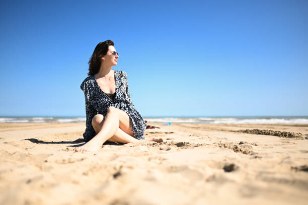 Woman relaxing on a sandy beach.
