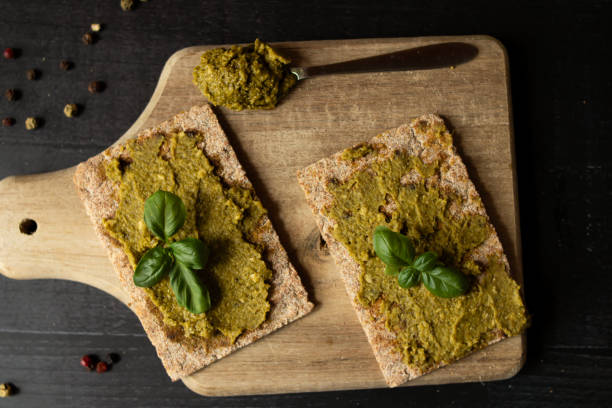 istock Fresh pesto sauce. on a dark background. ingredients 2157928041