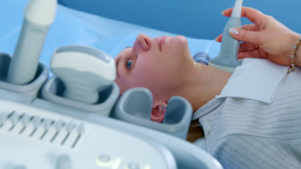 istock Close-Up of Thyroid Ultrasound Examination on Patient 2157928238