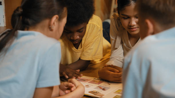 istock Caucasian girl sharing experience while reading a book with friend. Edification. 2157929808