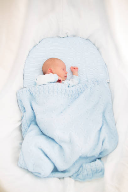 istock Newborn baby boy in white bassinet 2157929982
